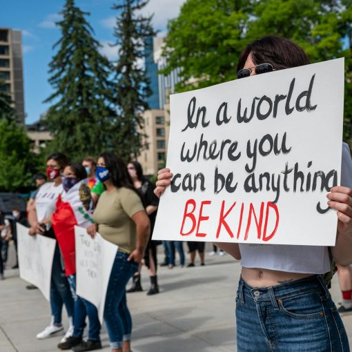 anonymous social justice warriors with placards during manifestation on street